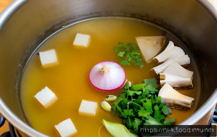 Home 30 한식 육수 만들기 - Photorealistic Korean-style homemade broth simmering in a large stainless steel stockpot, clear gold...